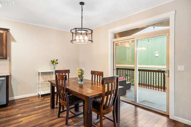 dining area with a chandelier, crown molding, and dark wood-type flooring