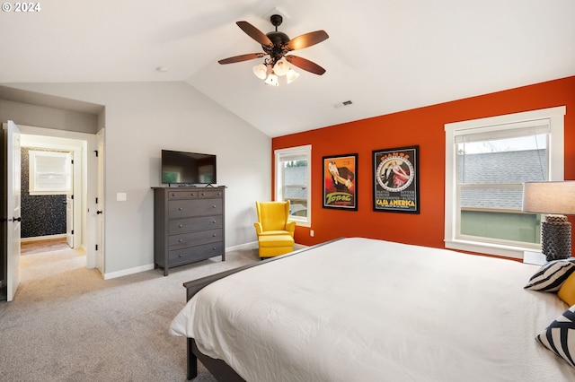 bedroom with ceiling fan, light carpet, and vaulted ceiling