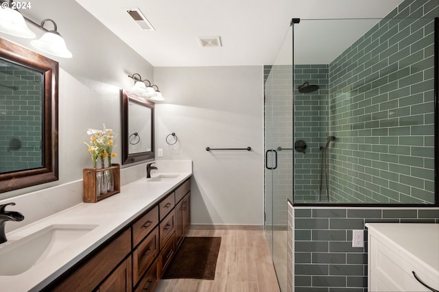 bathroom featuring hardwood / wood-style floors, vanity, and walk in shower