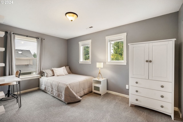 bedroom featuring light carpet