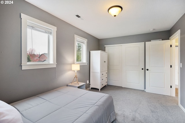 carpeted bedroom with a closet