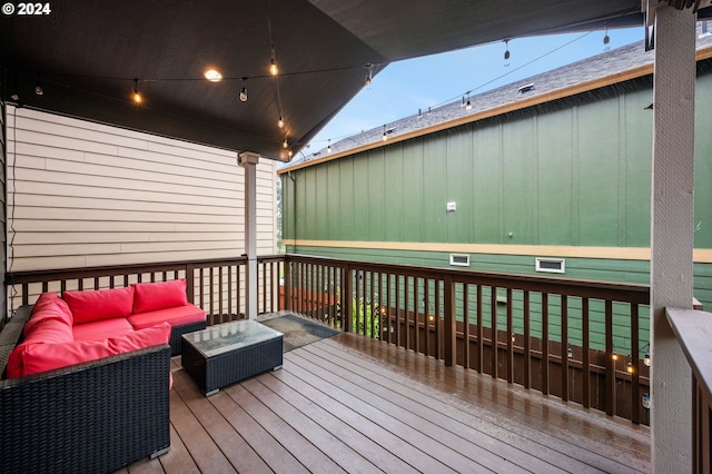 wooden terrace with an outdoor hangout area