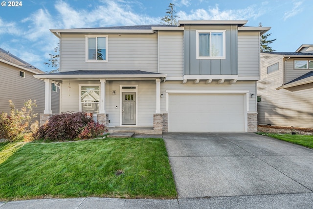 view of front of property featuring a garage and a front yard