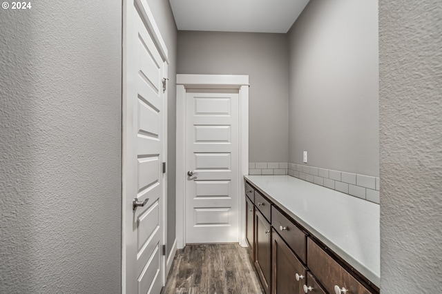 interior space featuring dark wood-type flooring and dark brown cabinetry