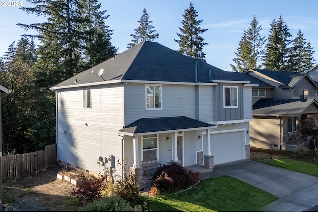 front of property featuring covered porch and a garage