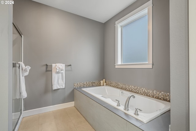 bathroom featuring independent shower and bath and tile patterned flooring