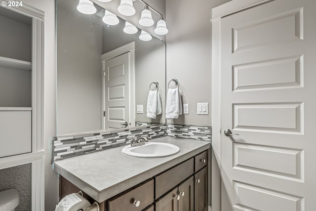 bathroom with vanity and tasteful backsplash