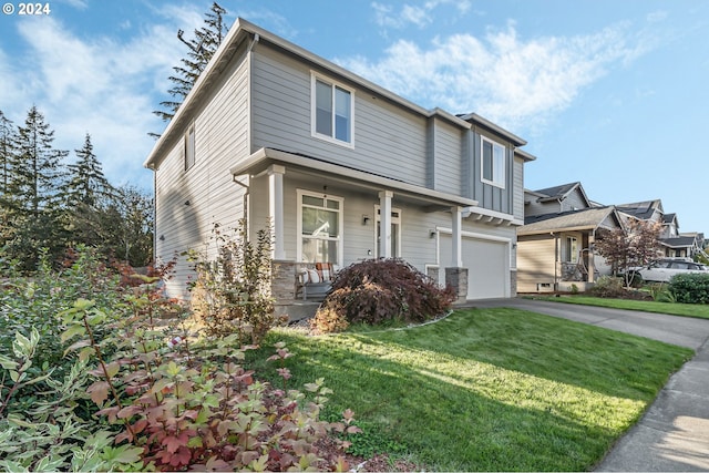 view of front of property featuring a porch, a garage, and a front lawn