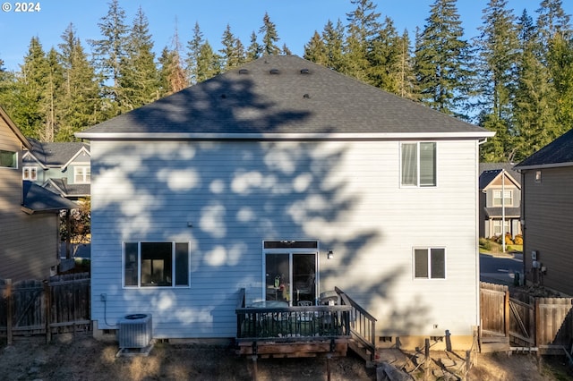 back of house with a deck and central air condition unit