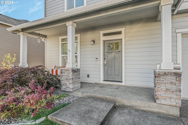 doorway to property with a porch