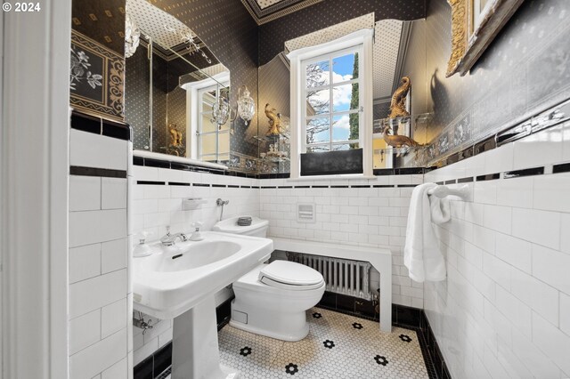 bathroom featuring tile walls, backsplash, toilet, and tile patterned flooring