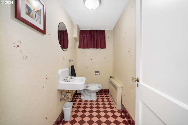 bathroom featuring radiator, toilet, and sink