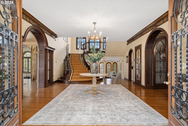 entryway with a chandelier, dark hardwood / wood-style flooring, and french doors