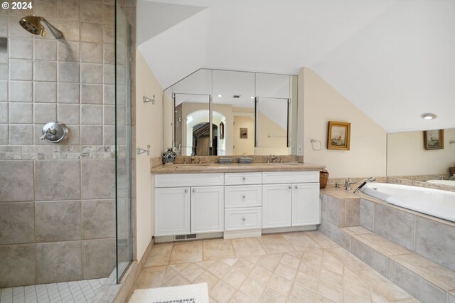 bathroom featuring vanity, lofted ceiling, separate shower and tub, and tile patterned floors