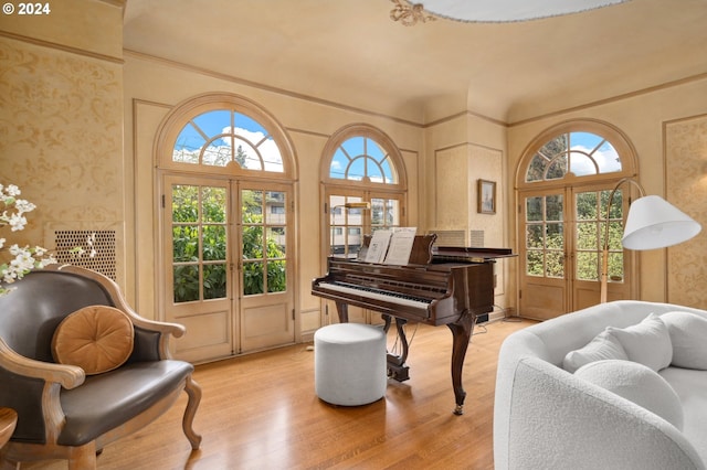 living area featuring french doors and light hardwood / wood-style floors