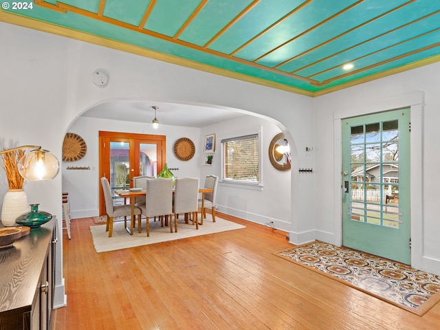 entryway with french doors, a healthy amount of sunlight, and light hardwood / wood-style flooring