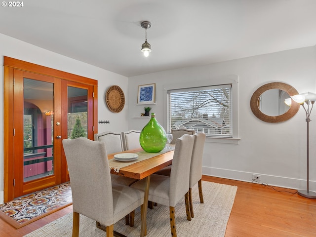 dining room featuring french doors and light wood-type flooring