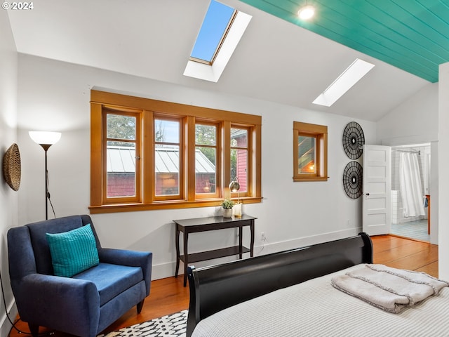 bedroom with light hardwood / wood-style floors and lofted ceiling