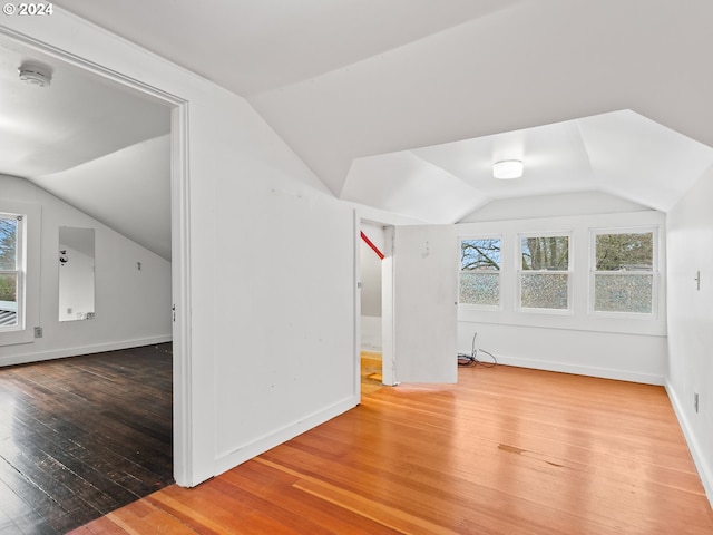 bonus room featuring vaulted ceiling and hardwood / wood-style flooring