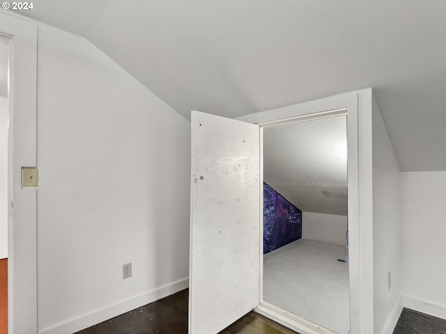 additional living space with lofted ceiling and dark hardwood / wood-style flooring