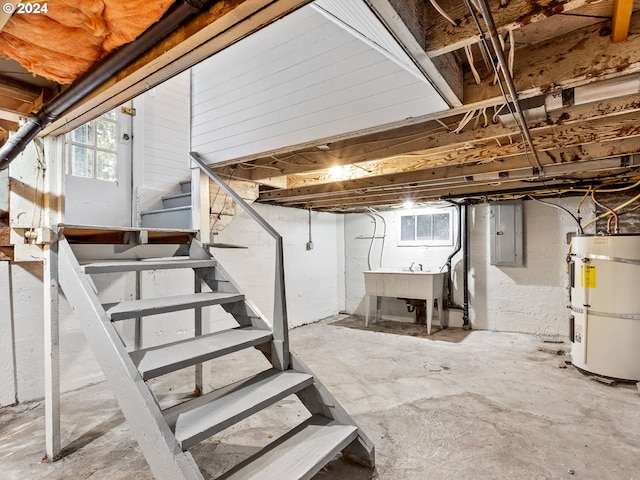 basement featuring sink, secured water heater, and electric panel