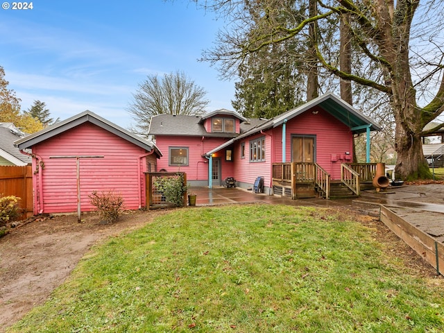 rear view of property with a patio area and a lawn