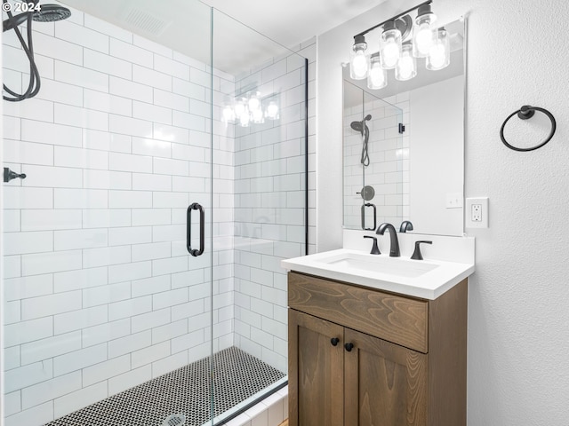 bathroom featuring an enclosed shower and vanity