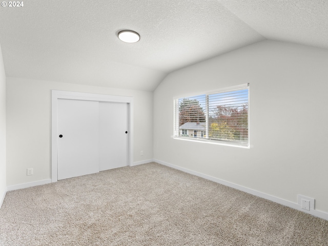 interior space featuring lofted ceiling and a textured ceiling