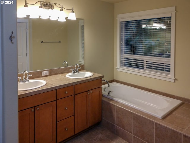 bathroom featuring vanity, a relaxing tiled tub, and tile patterned flooring