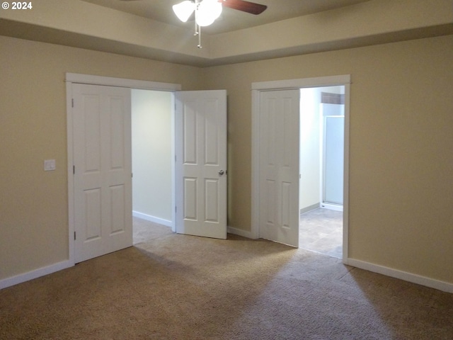 empty room featuring ceiling fan and light colored carpet