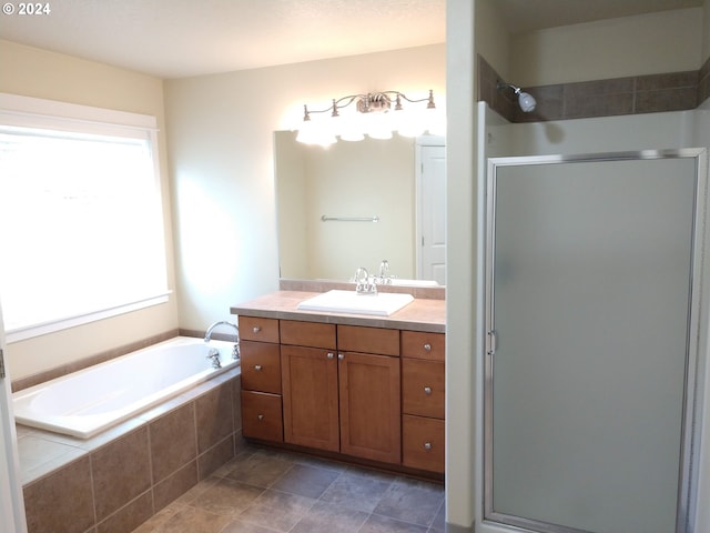 bathroom featuring shower with separate bathtub and vanity