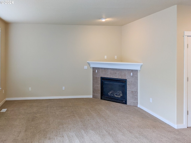 unfurnished living room featuring light colored carpet and a fireplace