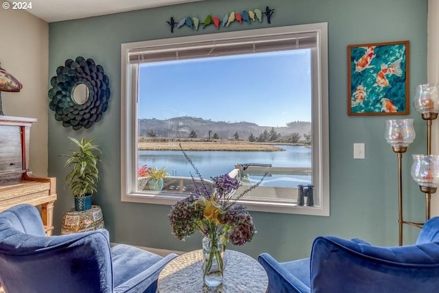 living area featuring a water and mountain view