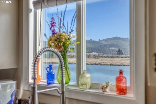 room details featuring a water and mountain view