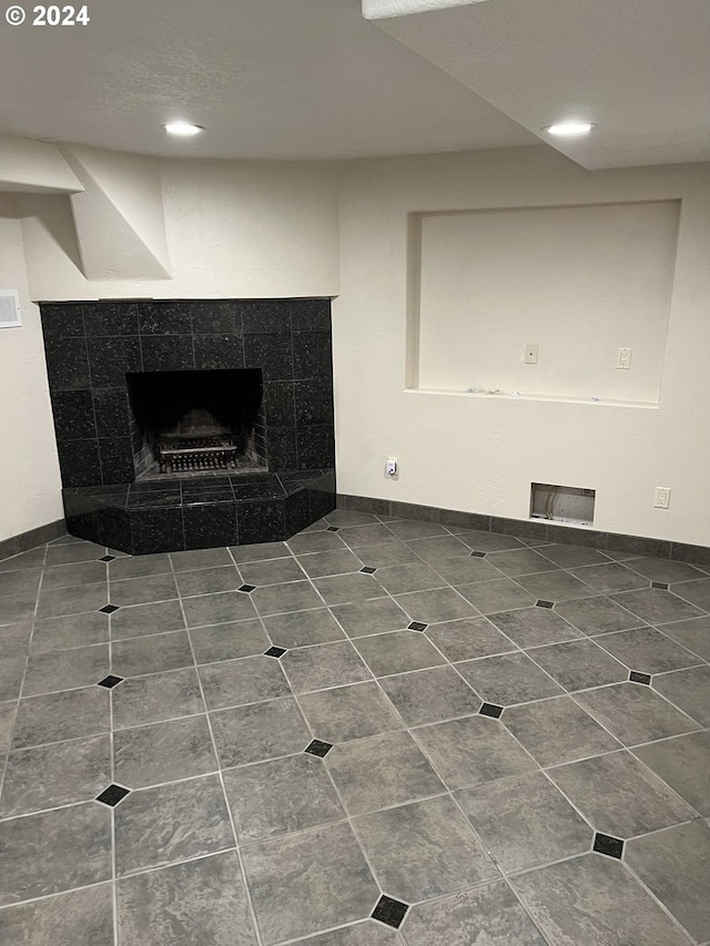 unfurnished living room with tile patterned flooring and a fireplace