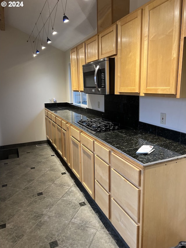 kitchen with light brown cabinets and black gas stovetop