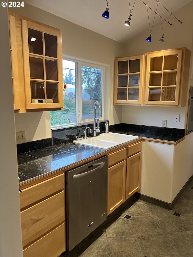 kitchen featuring dishwasher, light brown cabinets, sink, wall oven, and dark tile patterned floors