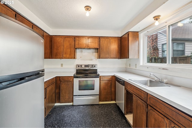 kitchen featuring sink, stainless steel appliances, and a textured ceiling