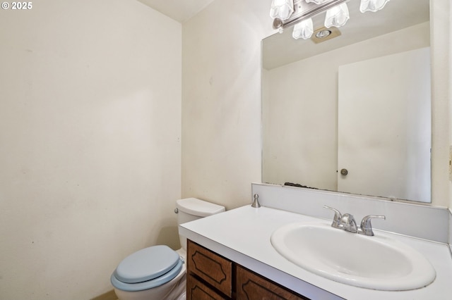 bathroom with toilet and vanity