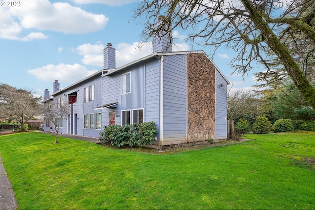 view of property exterior featuring a lawn