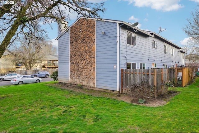 view of property exterior with a lawn