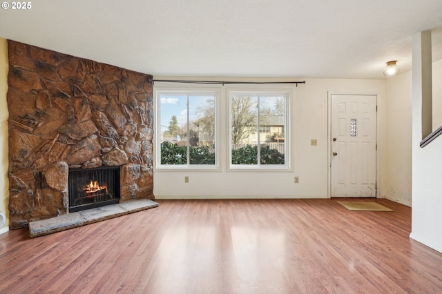 unfurnished living room featuring a fireplace and wood-type flooring