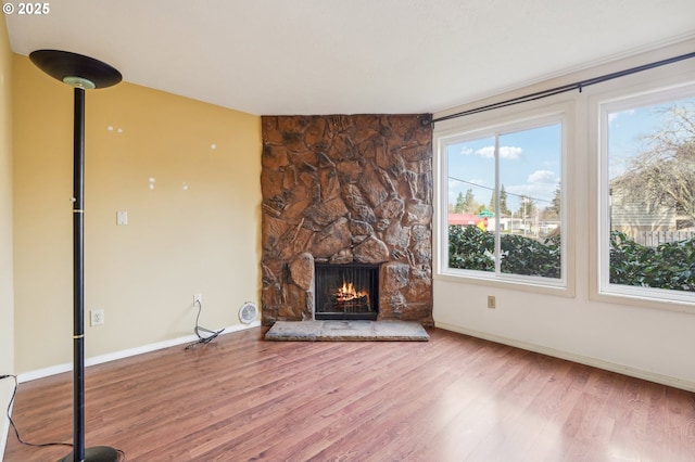 unfurnished living room featuring hardwood / wood-style floors and a fireplace