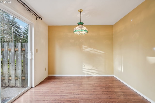 unfurnished dining area featuring hardwood / wood-style flooring