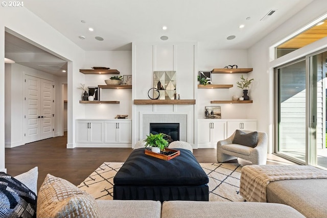 living room with hardwood / wood-style flooring and a tile fireplace