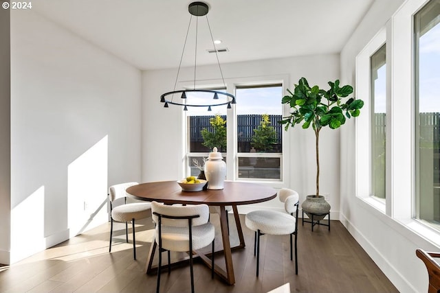 dining area with dark hardwood / wood-style floors