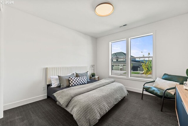 bedroom with dark carpet