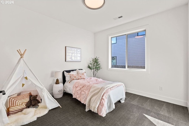 bedroom featuring dark carpet