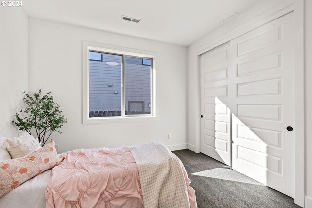 bedroom with dark colored carpet