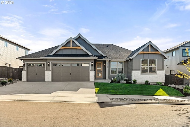 craftsman-style house with a garage and a front lawn